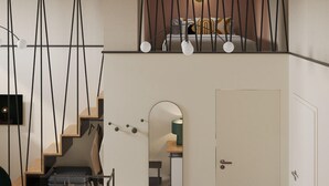 A modern loft bedroom with a loft bed, a staircase, and a view of the city. - QUO Milano - Hostel (Milan)