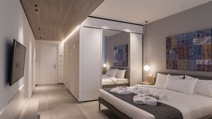 Una habitación de hotel moderna con una cama grande, un televisor de pantalla plana, un espejo y un cuadro abstracto y colorido en la pared.