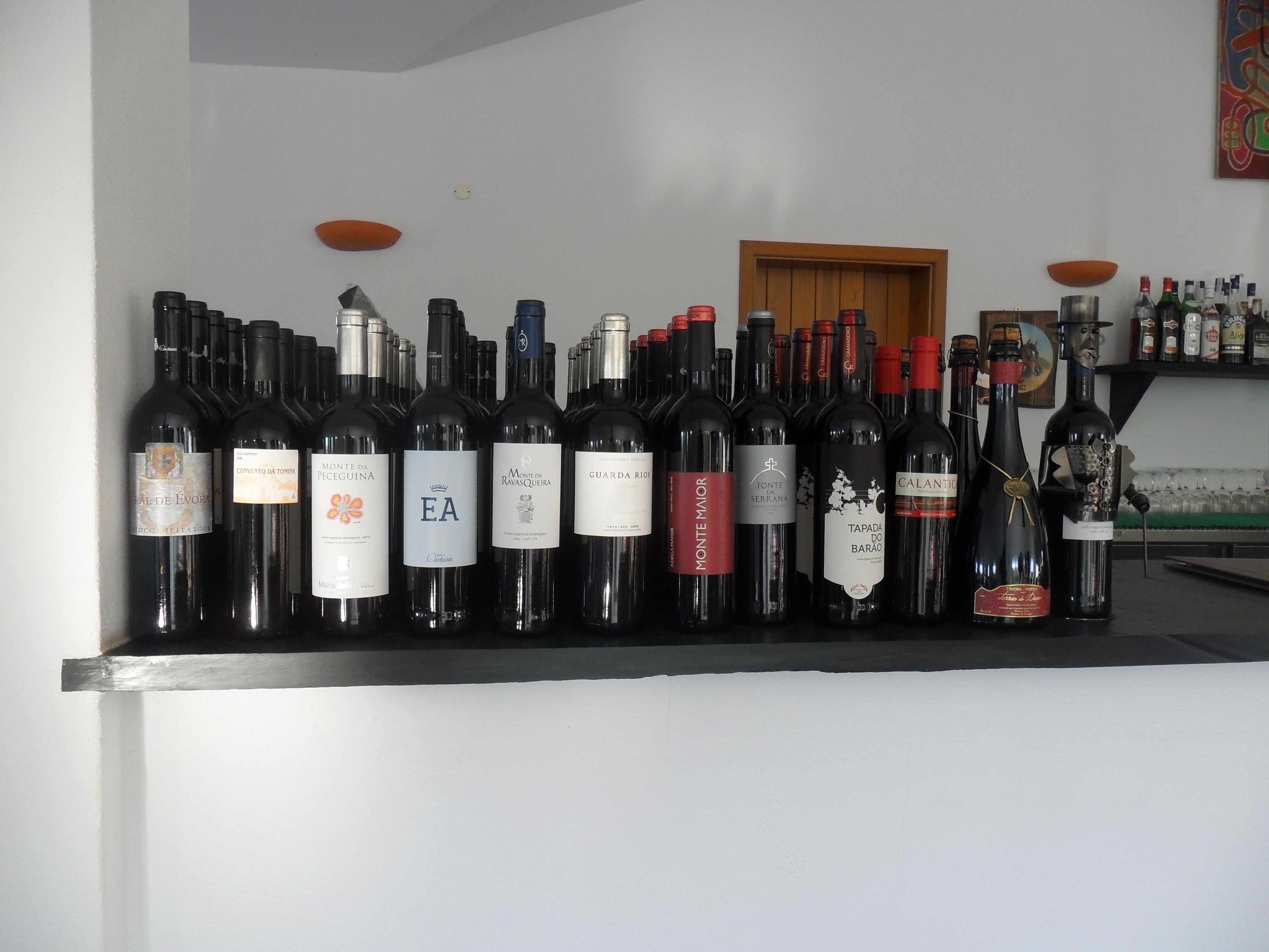 A row of wine bottles on a counter.