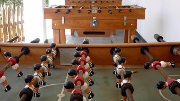 A foosball table with multiple players in red and white uniforms.
