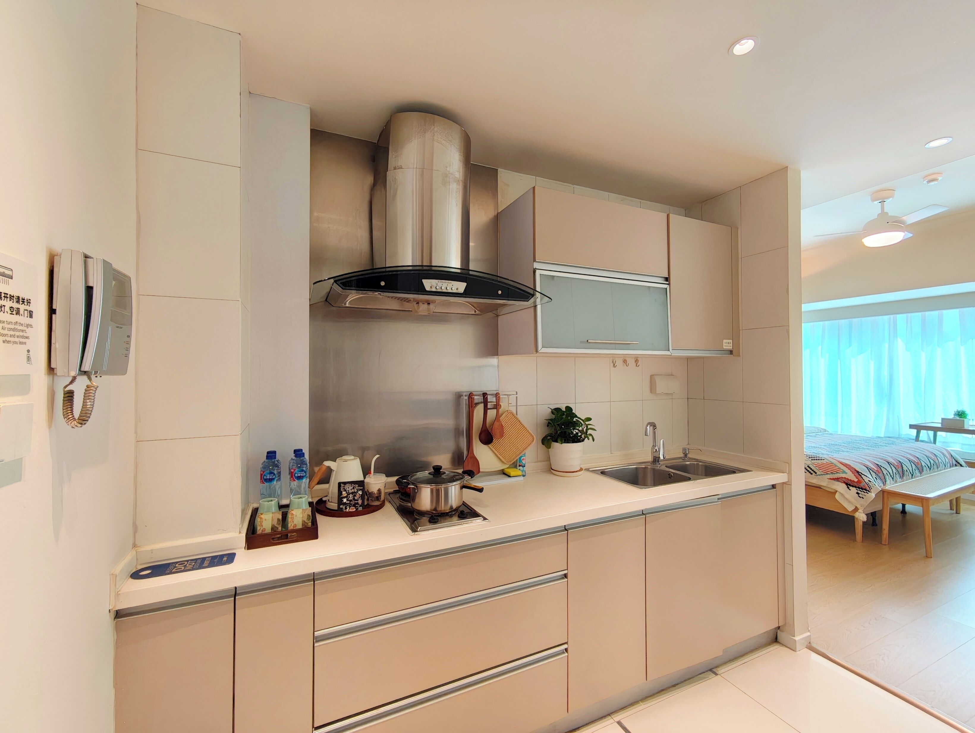 A modern kitchen with a built-in stove, a range hood, and a sink.