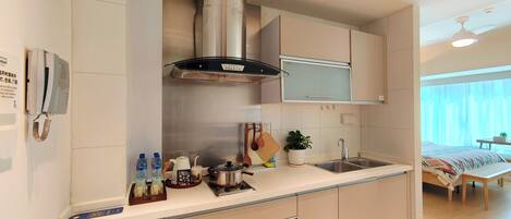 A modern kitchen with a built-in stove, a range hood, and a sink.