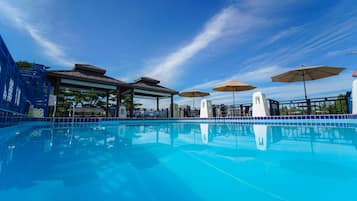Seasonal outdoor pool, open 9:30 AM to 8:00 PM, pool umbrellas