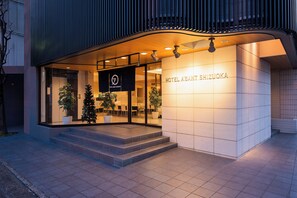 A modern hotel entrance with a sign reading "HOTEL ABANT SHIZUOKA," featuring a clean, contemporary design with a tiled facade and a welcoming entrance with steps. - Hotel Abant Shizuoka (Shizuoka)