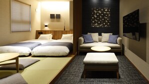 A hotel room with two beds, a sofa, a small table, and a tatami mat area. - Hotel Abant Shizuoka (Shizuoka)