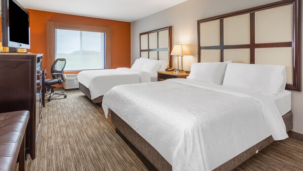 A hotel room with two beds, a desk with a chair, a TV, and a large window. - Holiday Inn Express Hotel & Suites Albert Lea - I-35 by IHG (Albert Lea)