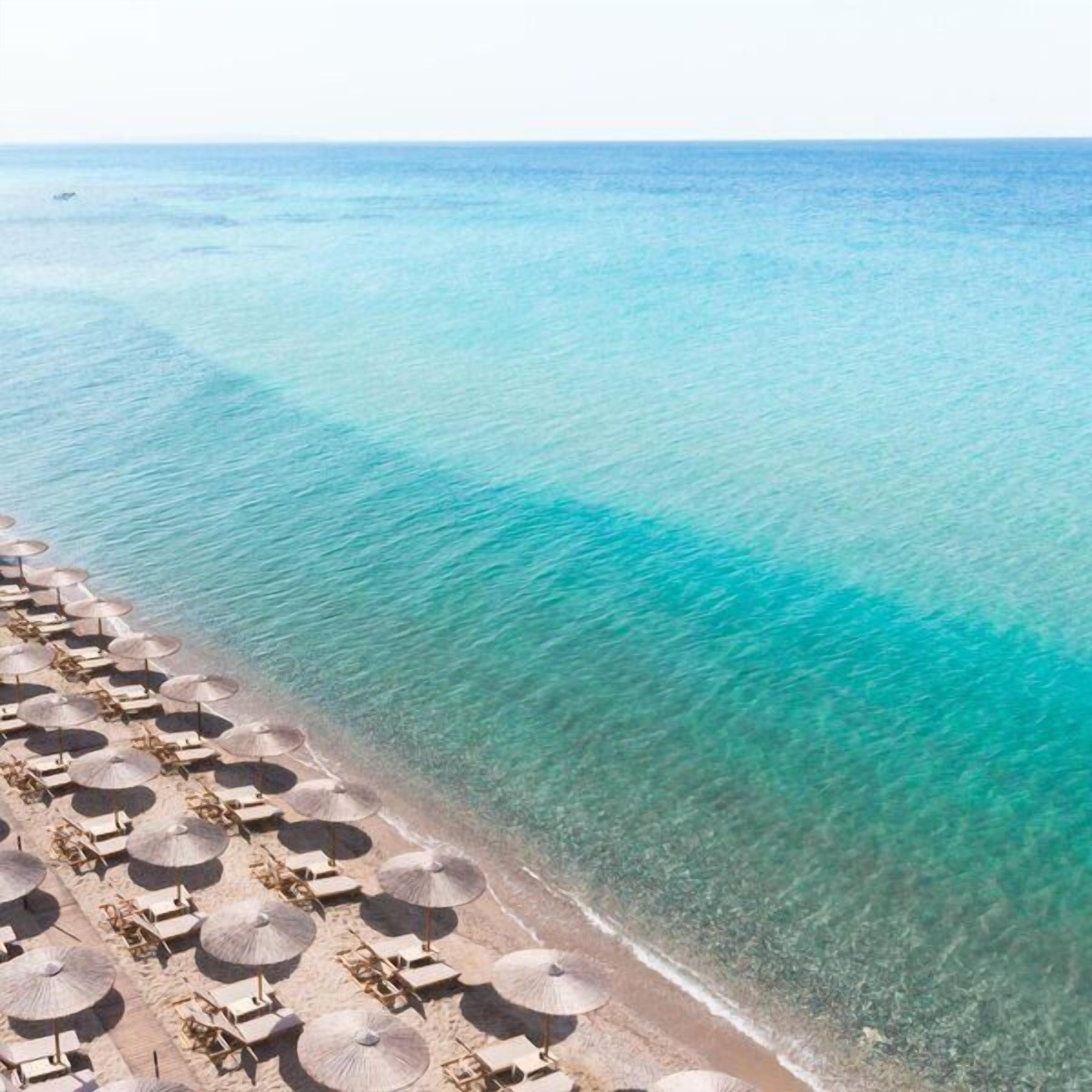 On the beach, sun-loungers, beach umbrellas, beach bar
