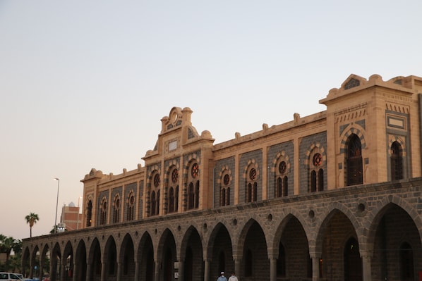 A historic building with multiple arches and a clock tower.