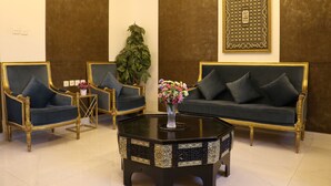 A room with two sofas, a coffee table, and a decorative wall panel.