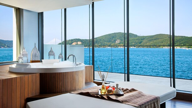 A modern bathroom with a large bathtub, a sink, and a view of the sea. - The Grand Tarabya Managed by Accor (Sariyer)