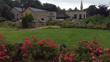 Surrounded by a lush lawn and vibrant flowers, Ann Graan offers a serene atmosphere.
