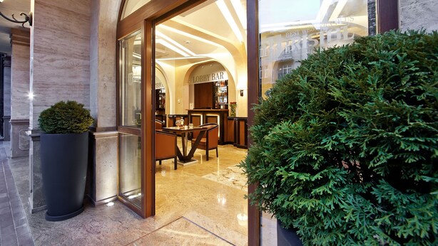 A lobby with a marble floor, a reception desk, and a bar area. - Best Western Plus Bristol Hotel (Sofia)