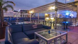 A rooftop bar with seating, a bar area, and a view of the city skyline. - Protea Hotel by Marriott Gaborone Masa Square (Gaborone)