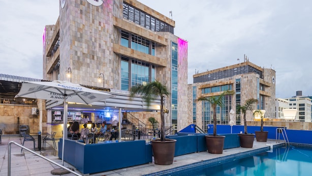 A hotel with a pool area, outdoor seating, and a bar. - Protea Hotel by Marriott Gaborone Masa Square (Gaborone)