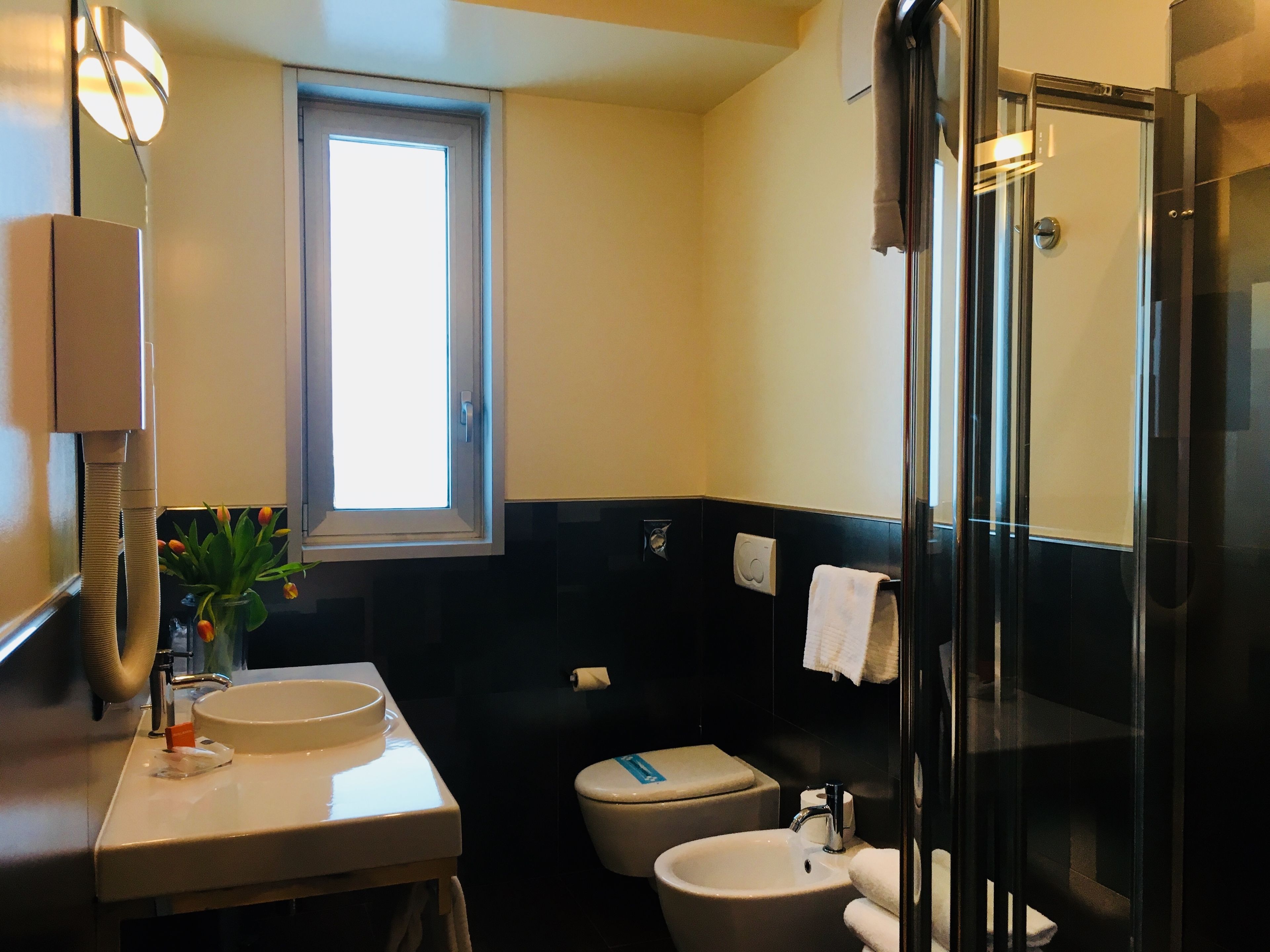 A bathroom with a sink, toilet, and shower.