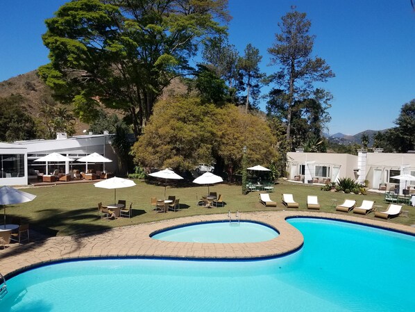 Indoor pool, outdoor pool, pool umbrellas, pool loungers