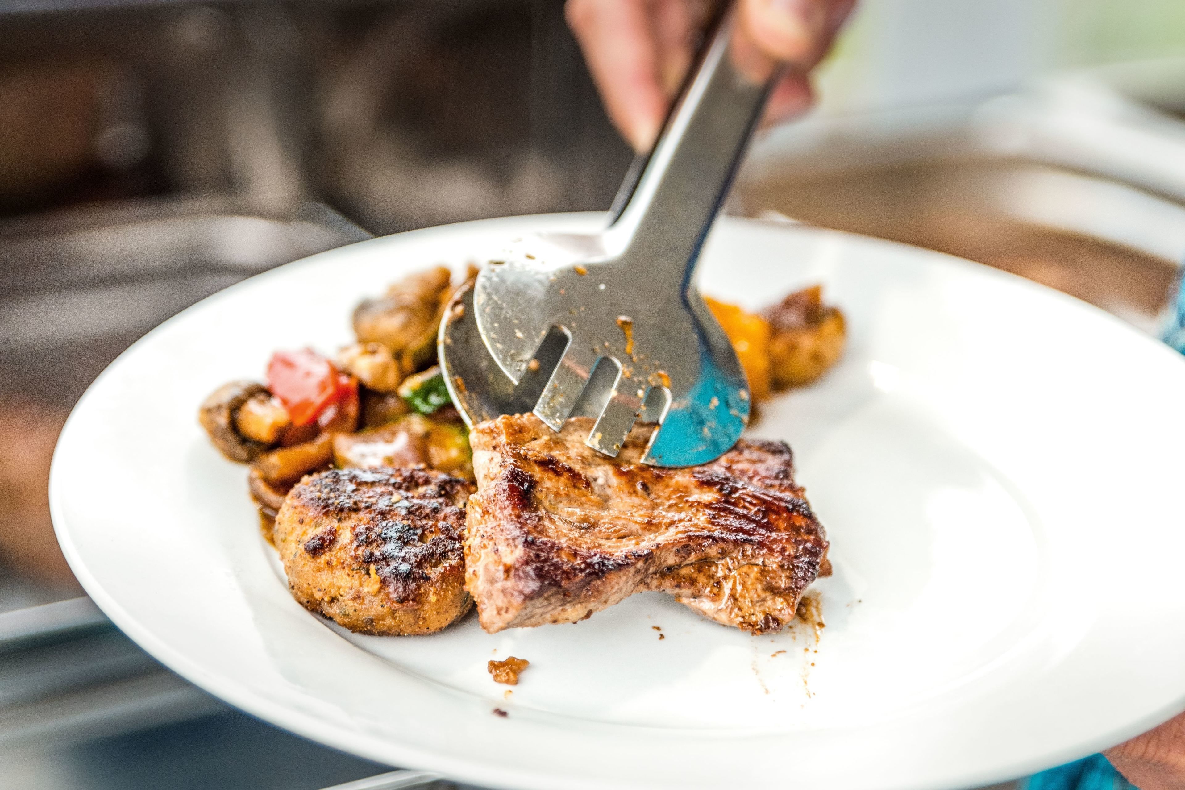 A plate with grilled meat and vegetables.