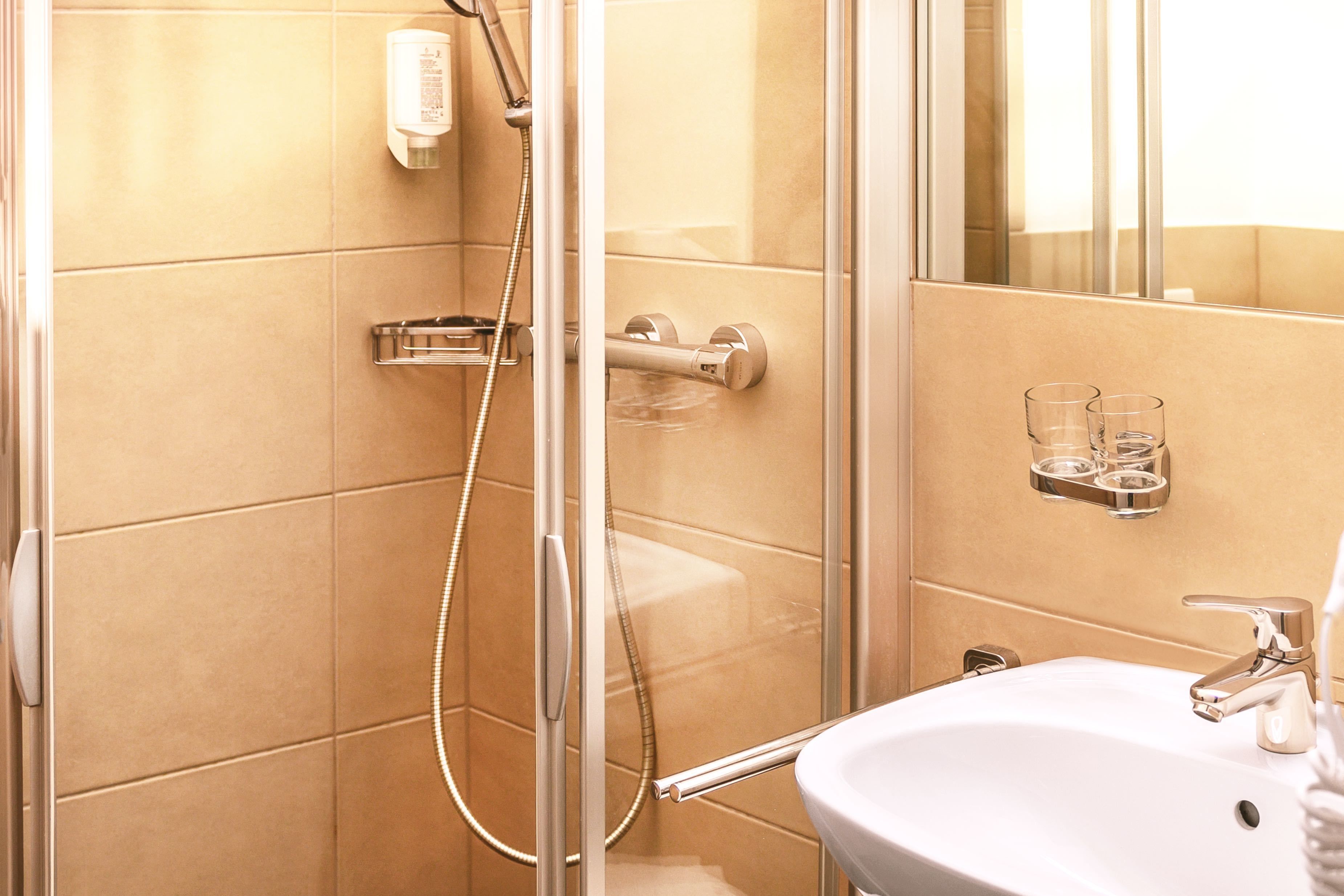 standard double room | bathroom | shower, hair dryer, towels