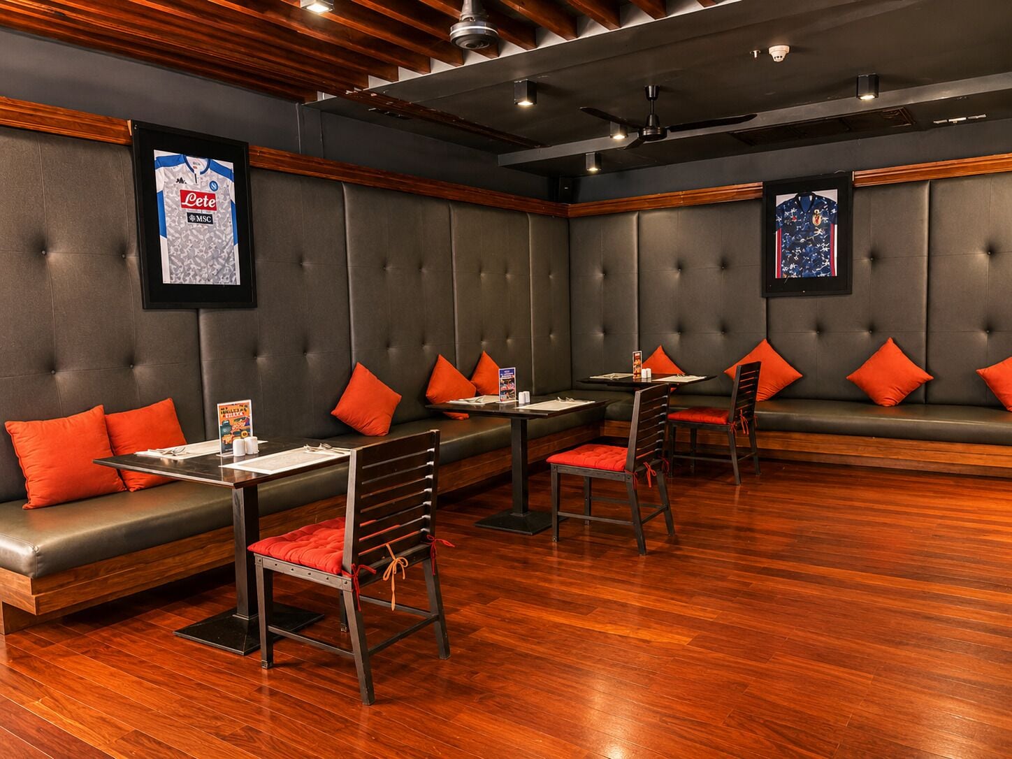 A restaurant with booths, tables, and chairs.