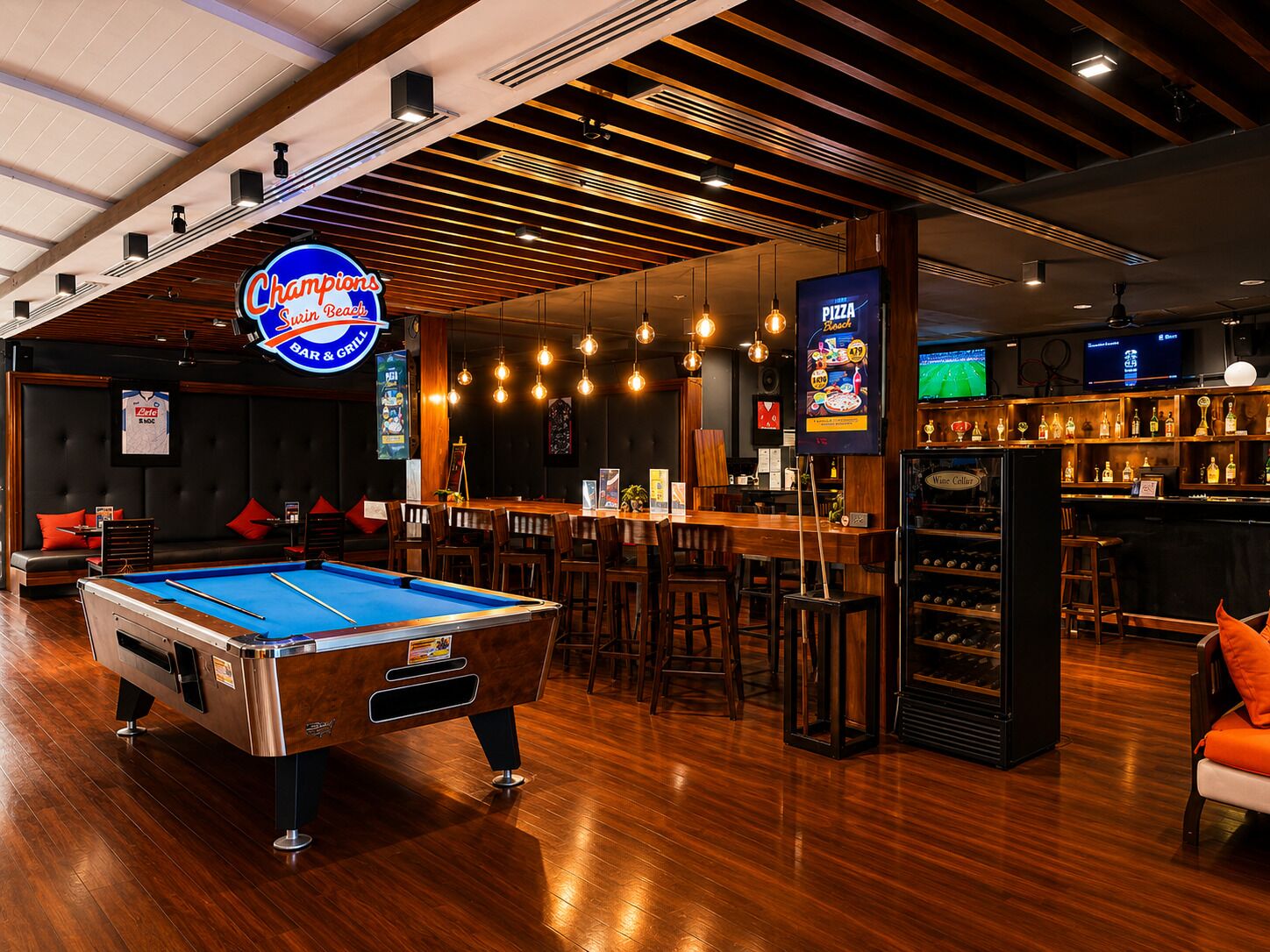 A billiards table, bar area, and seating with a pool table.
