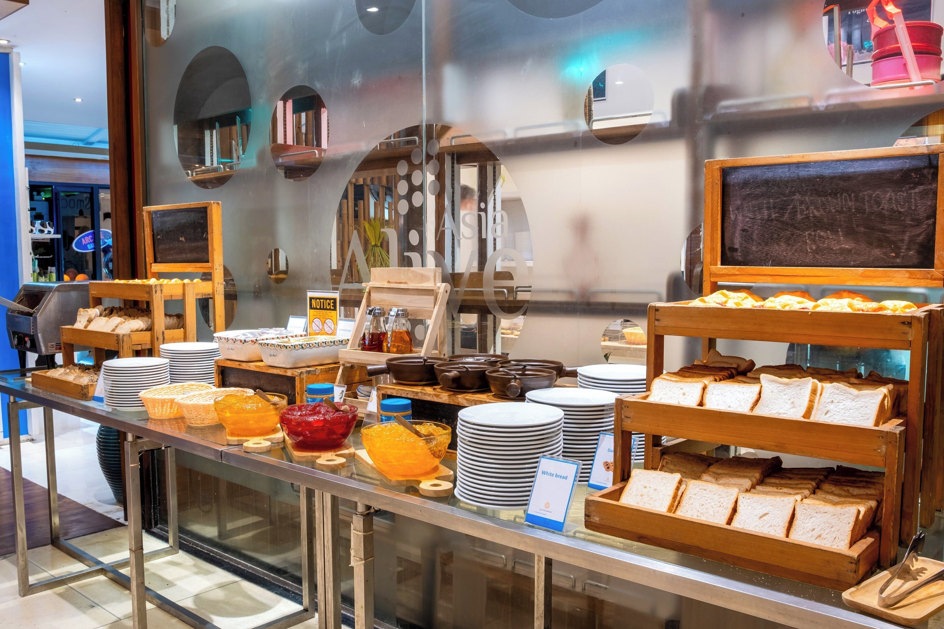 A breakfast buffet with various food items and utensils.