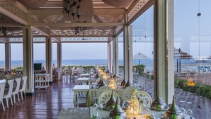 A covered outdoor dining area with tables set for a meal, overlooking the sea. - Rixos Sharm El Sheikh Adults Only 18 + (Sharm El Sheikh)
