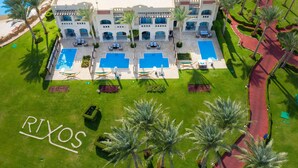 A large resort with multiple swimming pools, palm trees, and a well-maintained lawn. - Rixos Sharm El Sheikh Adults Only 18 + (Sharm El Sheikh)