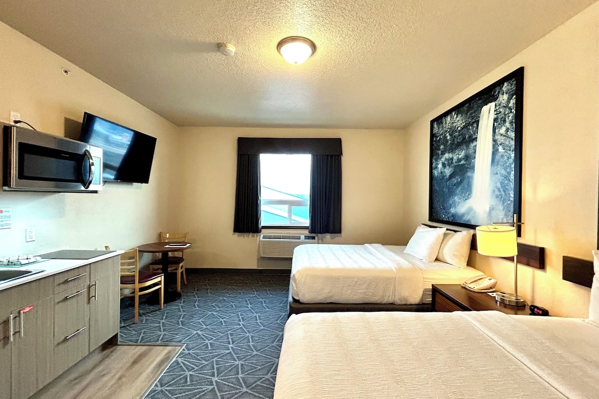 deluxe room, 2 queen beds, kitchen | pillow-top beds, desk, laptop workspace, blackout curtains