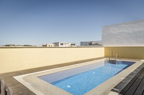 Relax by the rooftop pool surrounded by a deck and enjoy the urban views.