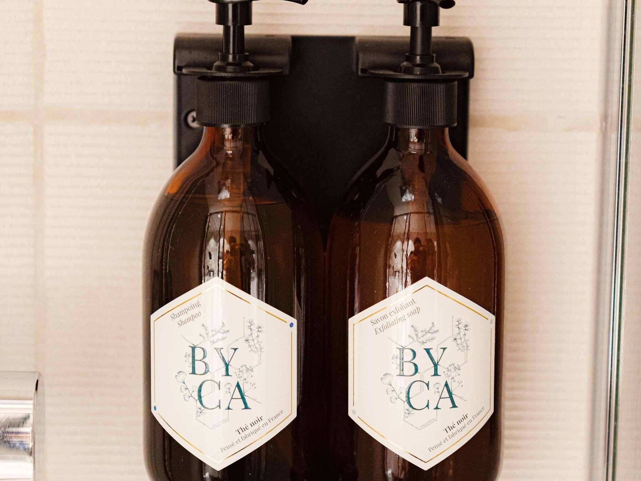 Two bottles of BY CA shampoo and soap.