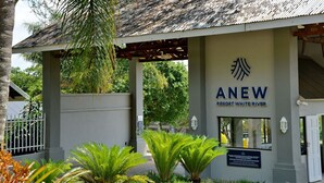 The entrance to ANEW Resort White River with a signboard, a covered entrance, and surrounding greenery. - ANEW Resort White River Mbombela (Mbombela)