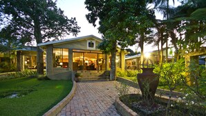 A modern building with a brick pathway leading to a glass entrance. - ANEW Resort White River Mbombela (Mbombela)