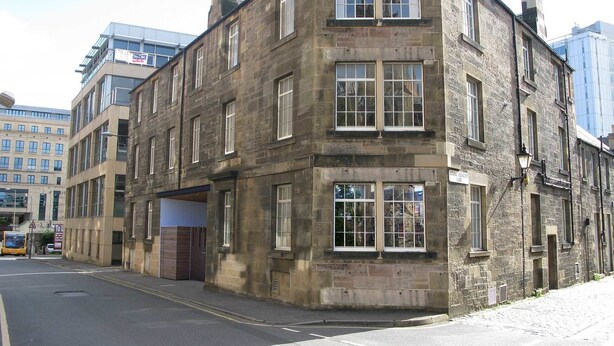 A corner building with multiple windows and a visible entrance. - Destiny Scotland - The Malt House Apartments (Edinburgh)