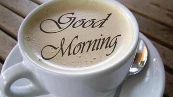 A cup of coffee with "Good Morning" written on the foam.