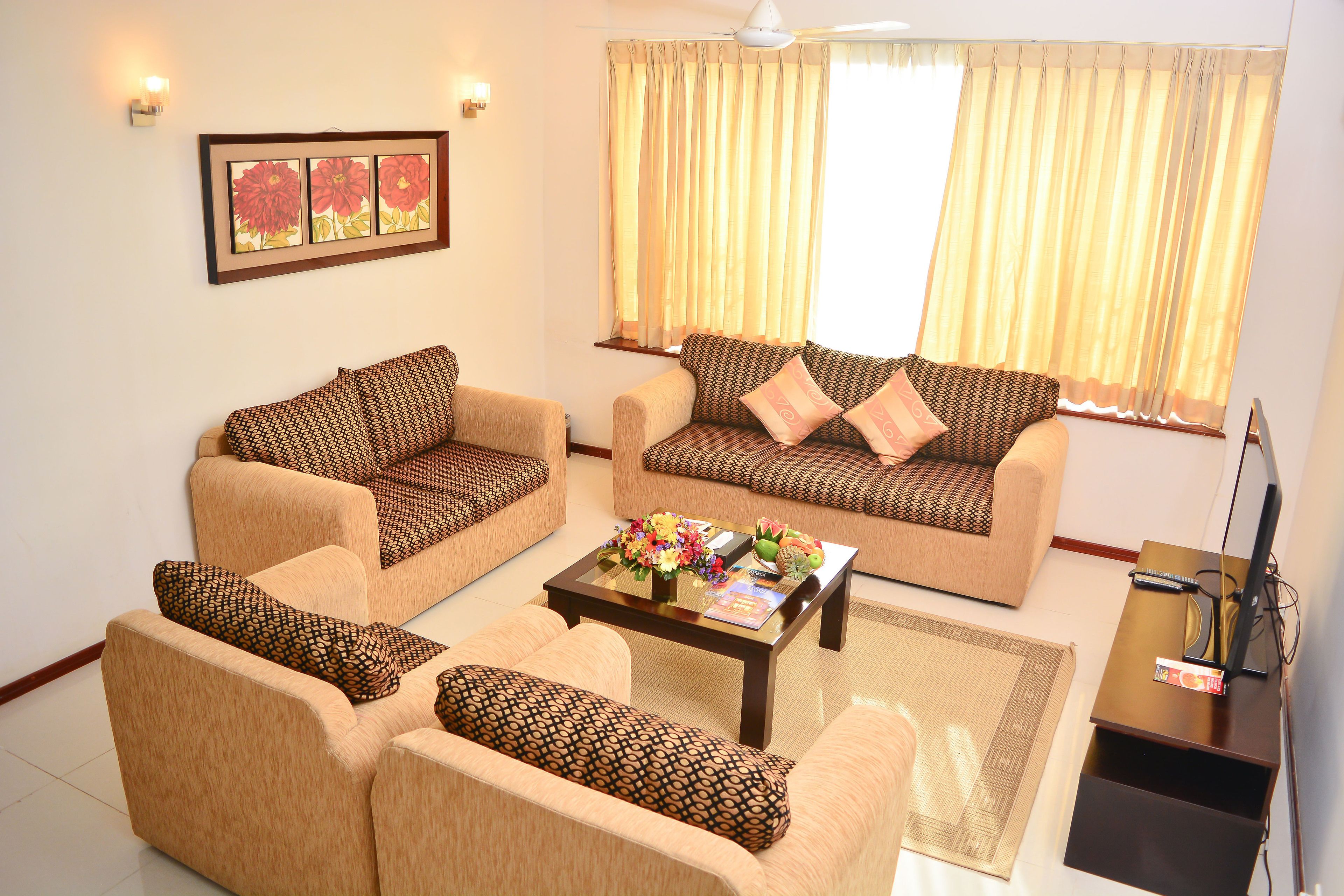 A living room with two sofas, a coffee table, and a TV stand.
