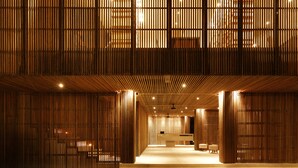 A modern interior with vertical wooden slats, a reception desk, and a seating area. - One Eleven Retreat (Keroboken Kelod)