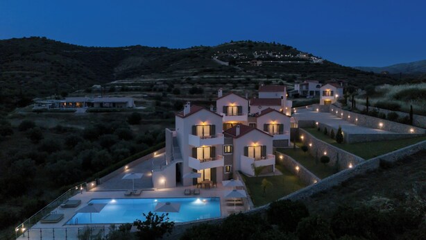 A modern villa with a swimming pool, multiple balconies, and a landscaped garden. - Anassia Villas (Nafplio)