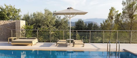 Seasonal outdoor pool, open 9:00 AM to 9:00 PM, pool umbrellas