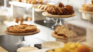A bakery display with various baked goods on wooden stands.