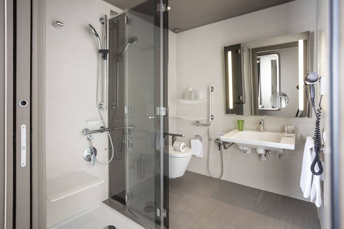 comfort room (accessible for disabled) | bathroom | shower, rainfall showerhead, designer toiletries, hair dryer