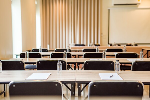 A classroom with rows of desks, chairs, and a whiteboard. - The Beach Village Resort (Sam Roi Yot)