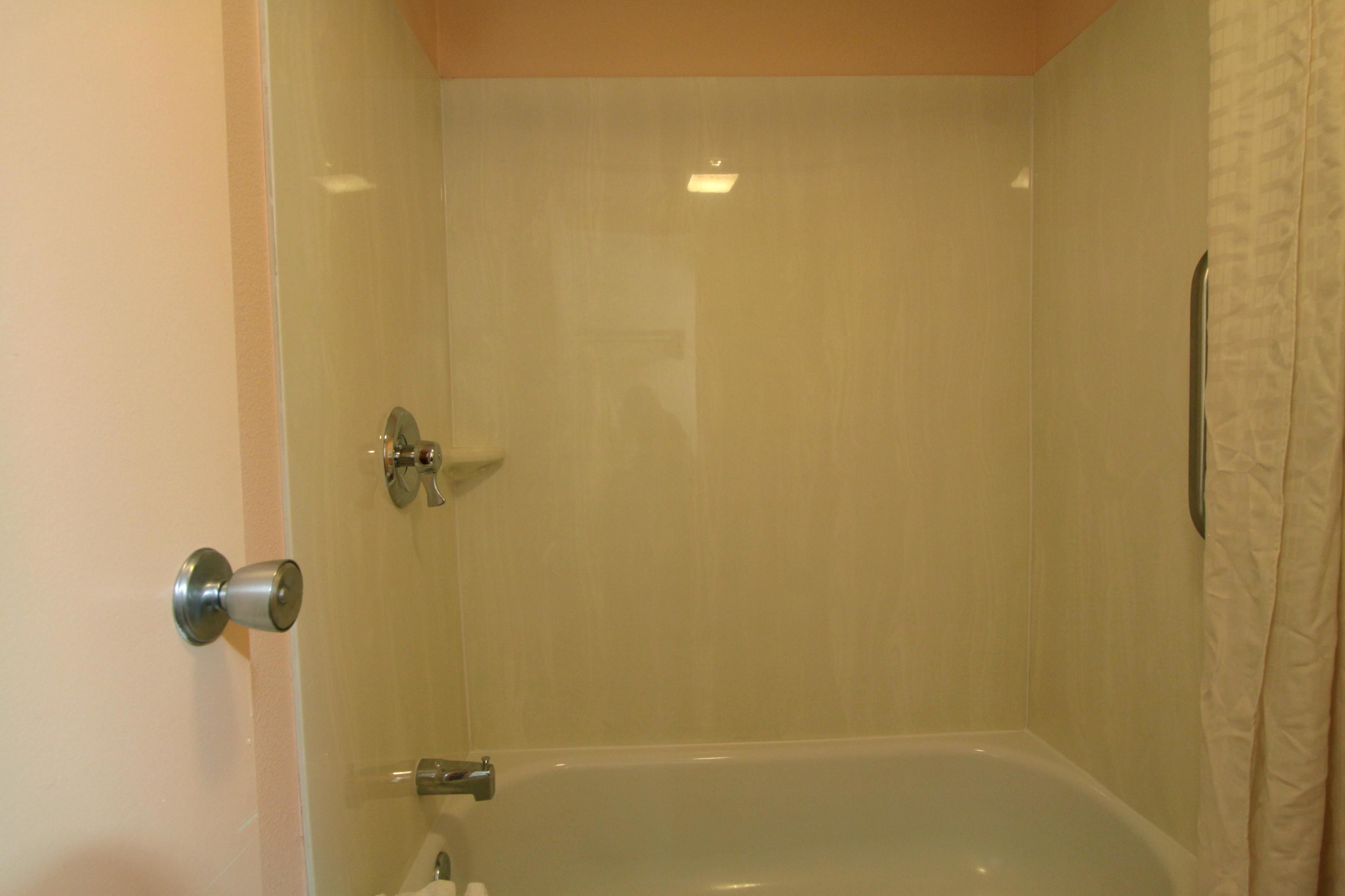 A bathroom with a bathtub, a shower, and a toilet.