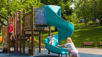 A playground with a slide and climbing structures.