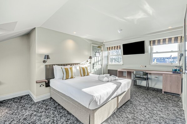 Deluxe Quadruple Room, City View | Premium bedding, pillowtop beds, desk, laptop workspace