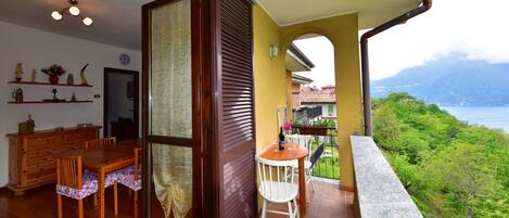 A balcony with a view of a mountainous landscape.