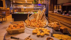 A buffet with various breads, pastries, and a knife on a table. - KYRIAD PRESTIGE MULHOUSE - Basel (Sausheim)