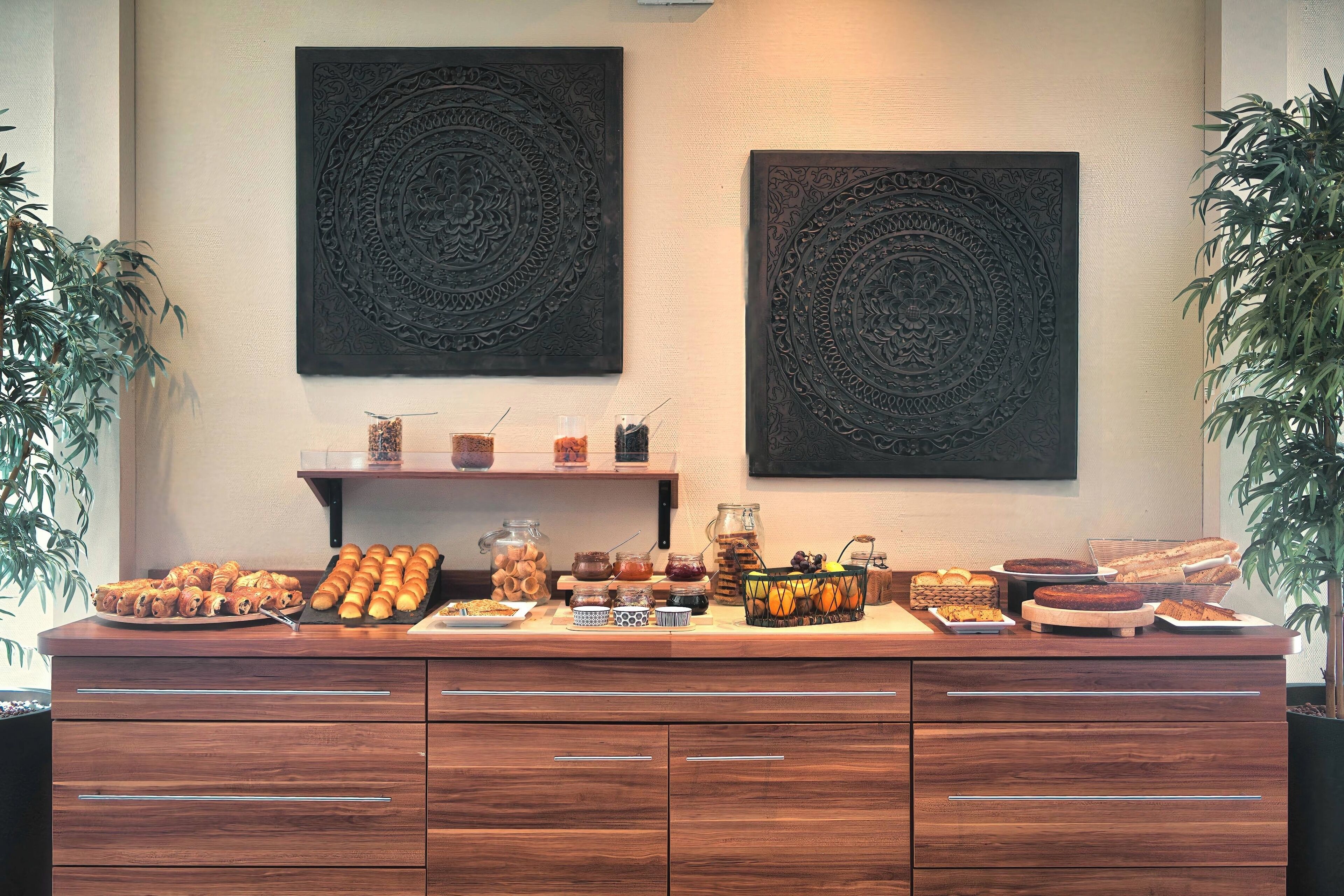 A buffet setup with various food items and decorative wall art.