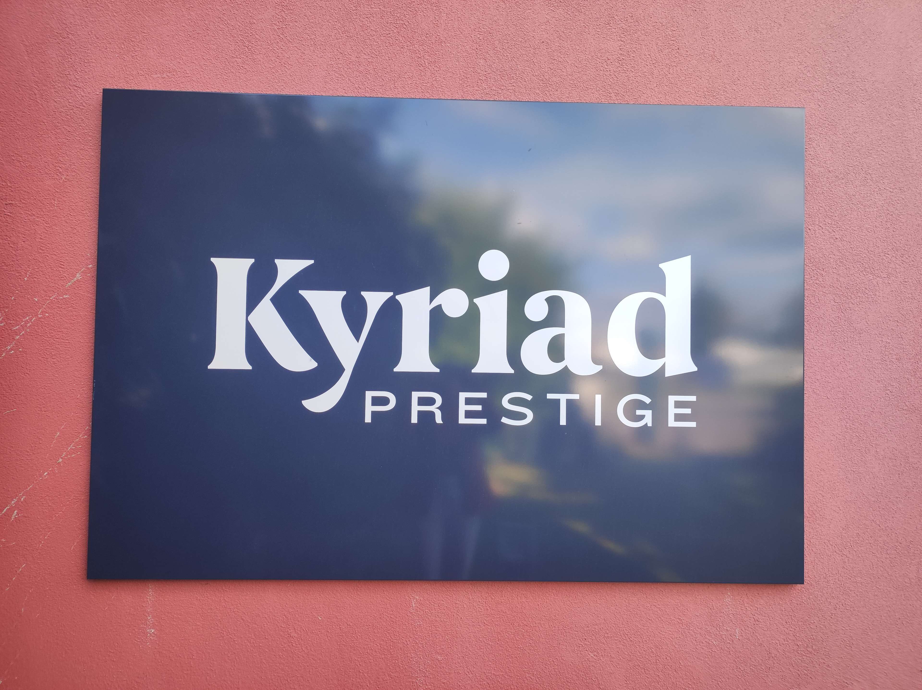 A sign with the text "Kyriad Prestige" on a dark background.