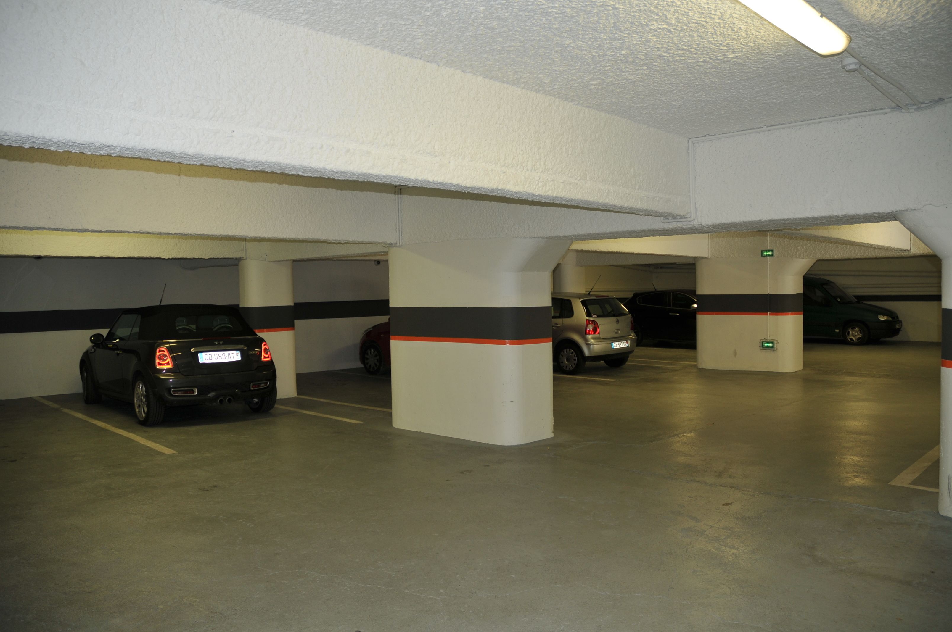 A multi-level parking garage with several cars parked.