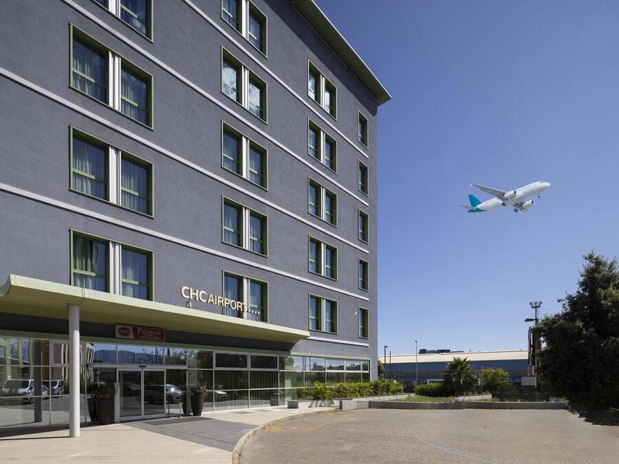 A modern building with a sign reading "CHCAIRPORT" and a large glass entrance.